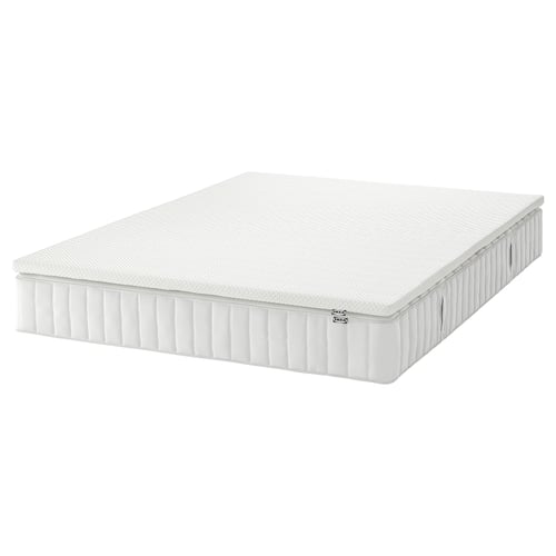 An IKEA VALEVÅG white memory foam and pocket spring mattress. Rectangular, it has a quilted design and is white.