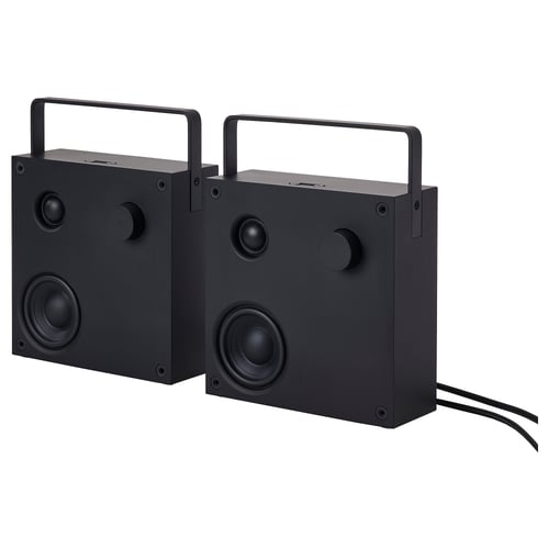 Two black VAPPEBY bluetooth speakers, rectangular, with handles and round speaker grills, connected by cables.