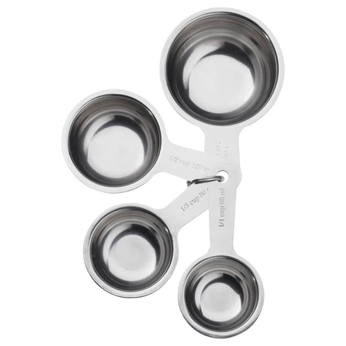 Four connected stainless steel measuring cups in varying sizes, shaped for nested storage. Ideal kitchen tool for precise measurements.