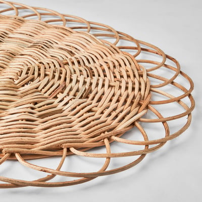 Handwoven rattan place mat. Intricate pattern, natural finish. Rounded edges, evenly constructed.