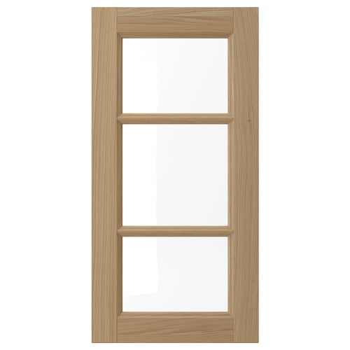 The VEDHAMN kitchen cabinet a natural wooden frame with glass panels, combining warmth and modern design.