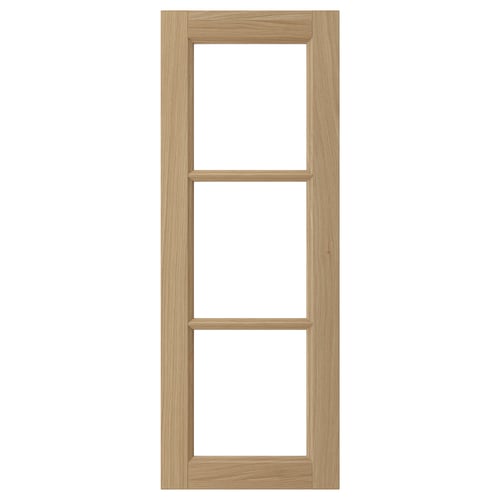 This image shows a VEDHAMN kitchen cabinet door in natural wood with a rectangular design featuring solid oak frames and two glass panels.