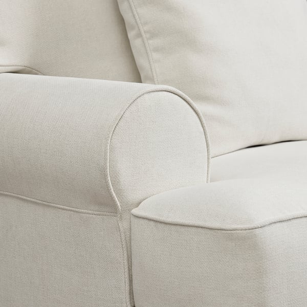 Light grey sofa close-up. Soft, textured fabric. Deep cushions, high back. Quality stitching detail.