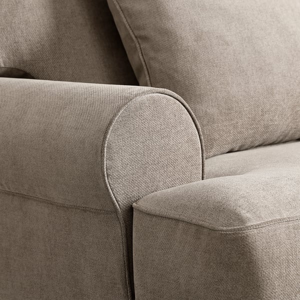 Notched upholstered sofa arm in plush, textured fabric, showcasing soft cushion and stitching detail.