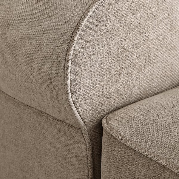 Close-up of a soft, beige sofa with plush fabric and sophisticated stitching, showcasing its high-quality, comfortable design.