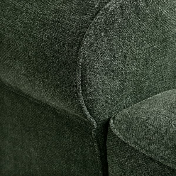 Close-up of dark green fabric, soft and textured, showcasing quality upholstery.