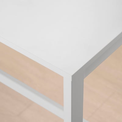 Modern, sleek table with smooth white top, showing quality craftsmanship and clean lines.