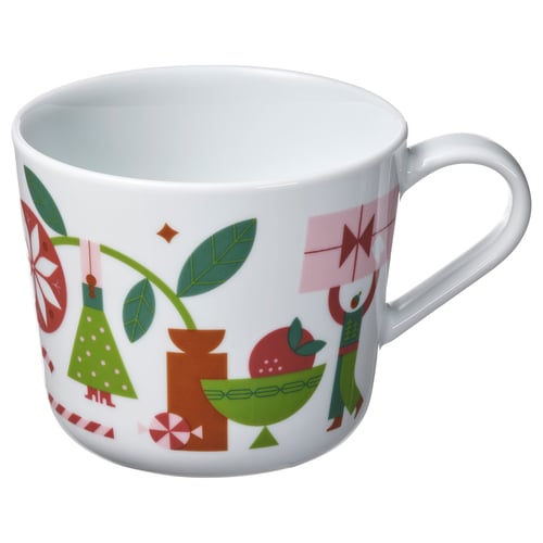 White ceramic mug with festive red, green, and pink holiday designs; round shape with a large handle.