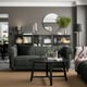 Modern living room with VISKAFORS sofa, plants, and dark decor.