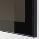 Close-up of a glossy black glass cabinet door.